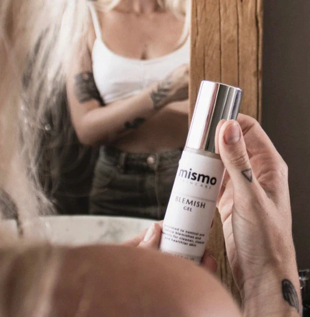 Image of a young girl holding a tube of blemish gel with both hands. For acne relief and to treat breakouts. 